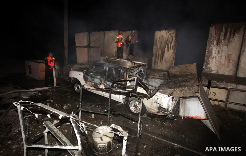 Palestinians extinguish a fire after Israeli air strikes targeted an electricity generator that fed the house of Palestinian Prime Minister in Gaza strip Ismail Haniyeh in Gaza City November 15, 2012. Israeli aircraft at...