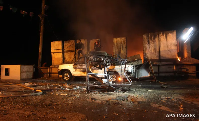Palestinians extinguish a fire after Israeli air strikes targeted an electricity generator that fed the house of Palestinian Prime Minister in Gaza strip Ismail Haniyeh in Gaza City November 15, 2012. Israeli aircraft at...
