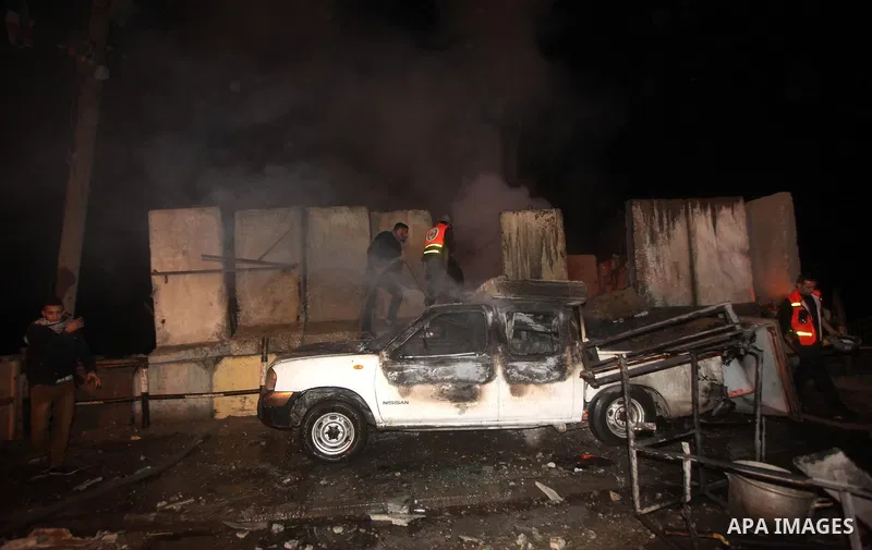 Palestinians extinguish a fire after Israeli air strikes targeted an electricity generator that fed the house of Palestinian Prime Minister in Gaza strip Ismail Haniyeh in Gaza City November 15, 2012. Israeli aircraft at...