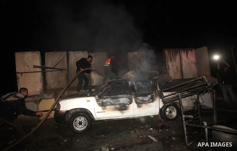Palestinians extinguish a fire after Israeli air strikes targeted an electricity generator that fed the house of Palestinian Prime Minister in Gaza strip Ismail Haniyeh in Gaza City November 15, 2012. Israeli aircraft at...