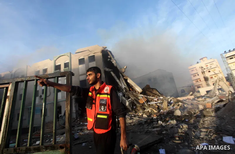 A Palestinian fireman points to an unexploded missile (not seen) after an Israeli air strike on the building of Interior Ministry building in Gaza City November 16, 2012. Egypt's prime minister prepared to visit the Gaza...