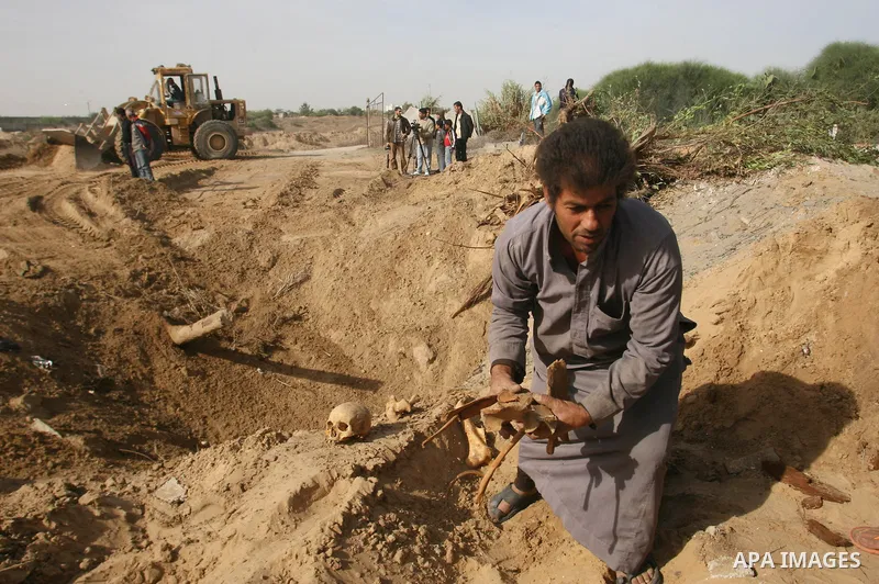 A Palestinian man carries bones from a grave after an Israeli airstrike on a cemetery in the southern of Gaza strip town of Rafah on November 16, 2012. Missiles continue to be fired on Israeli targets by Palestinian mili...