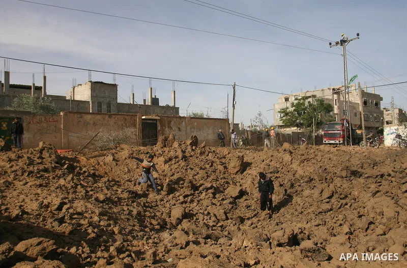 Palestinian children combine bones from a grave after an Israeli airstrike on a cemetery in the southern of Gaza strip town of Rafah on November 16, 2012. Missiles continue to be fired on Israeli targets by Palestinian m...