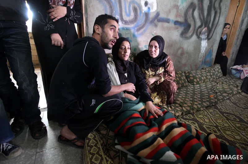 Relatives of 10-month-old Palestinian girl, Hanen Tafesh, killed the day before in an Israeli air strike, react before her funeral in Gaza City, on November 16, 2012. Israeli warplanes carried out multiple new air strike...