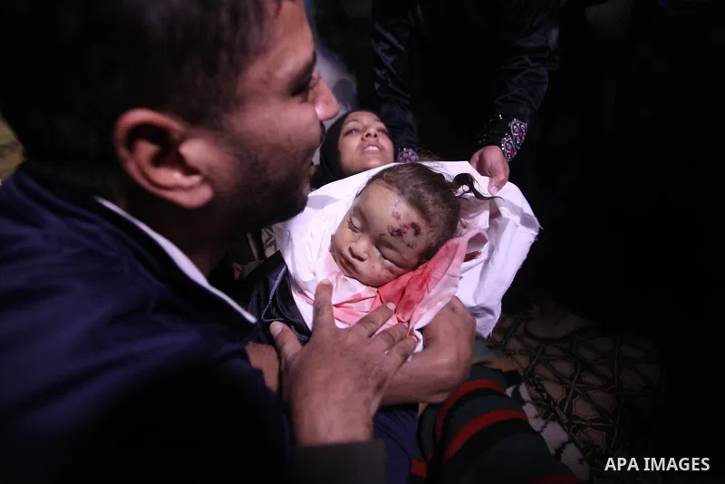 The father of 10-month-old Palestinian girl, Hanen Tafesh, killed the day before in an Israeli air strike, carries her body before her funeral in Gaza City, on November 16, 2012. Israeli warplanes carried out multiple ne...