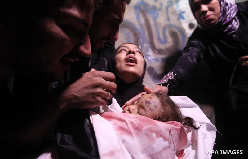 The mother of 10-month-old Palestinian girl, Hanen Tafesh, killed the day before in an Israeli air strike, mourns over her body before her funeral in Gaza City, on November 16, 2012. Israeli warplanes carried out multipl...