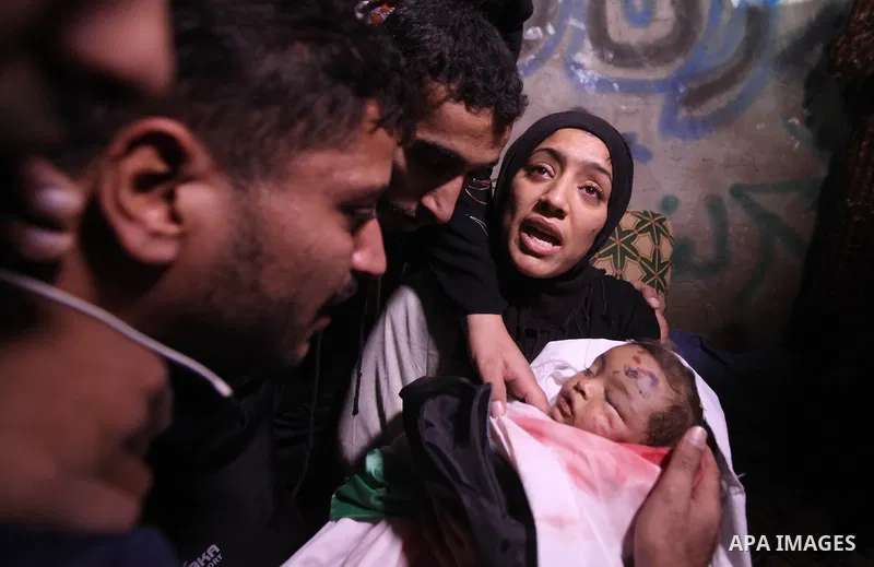 The mother of 10-month-old Palestinian girl, Hanen Tafesh, killed the day before in an Israeli air strike, mourns over her body before her funeral in Gaza City, on November 16, 2012. Israeli warplanes carried out multipl...