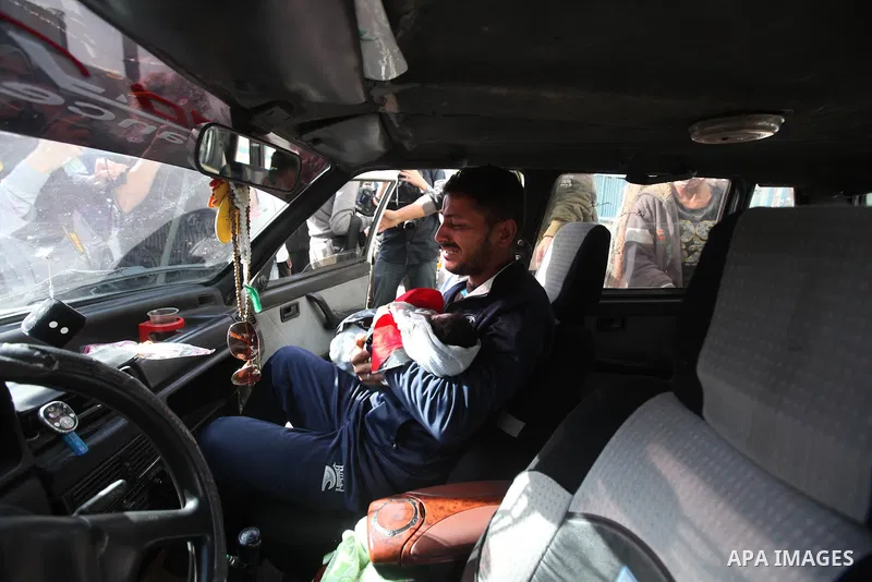 The father of 10-month-old Palestinian girl, Hanen Tafesh, killed the day before in an Israeli air strike, carries her body before her funeral in Gaza City, on November 16, 2012. Israeli warplanes carried out multiple ne...