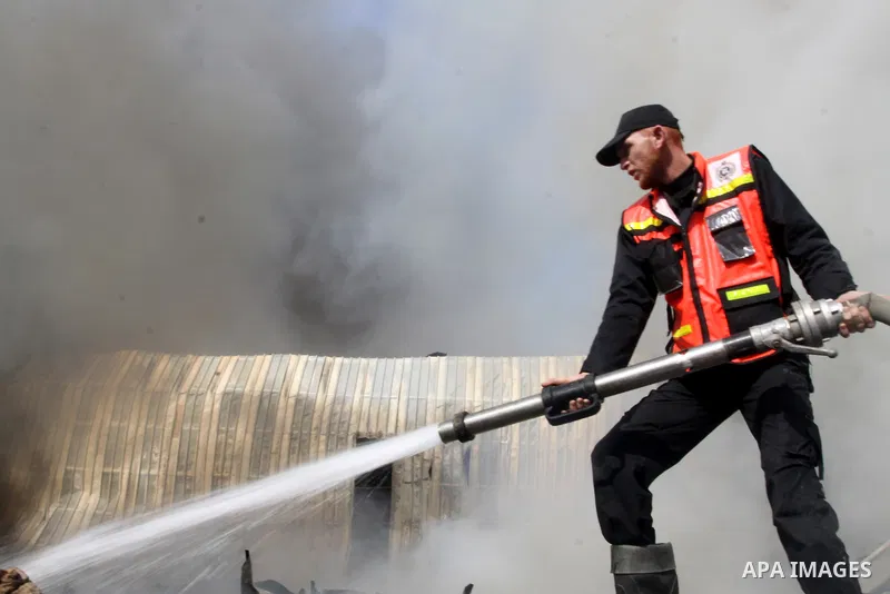 Firefighters try to extinguish a fire in a factory which according to Palestinians was hit by an Israeli air strike in Gaza November 16, 2012. Egyptian Prime Minister Hisham Kandil arrived in the Gaza Strip on Friday to...