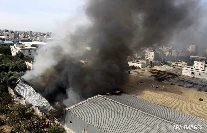 Smoke rises from a factory which according to Palestinians was hit by an Israeli air strike in Gaza November 16, 2012. Egyptian Prime Minister Hisham Kandil arrived in the Gaza Strip on Friday to show solidarity with the...