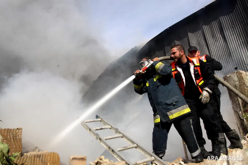 Firefighters try to extinguish a fire in a factory which according to Palestinians was hit by an Israeli air strike in Gaza November 16, 2012. Egyptian Prime Minister Hisham Kandil arrived in the Gaza Strip on Friday to...