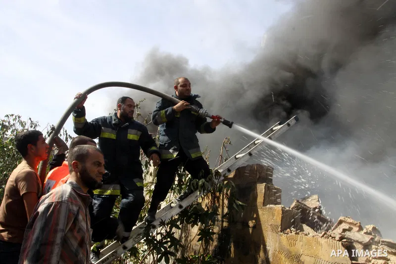 Firefighters try to extinguish a fire in a factory which according to Palestinians was hit by an Israeli air strike in Gaza November 16, 2012. Egyptian Prime Minister Hisham Kandil arrived in the Gaza Strip on Friday to...