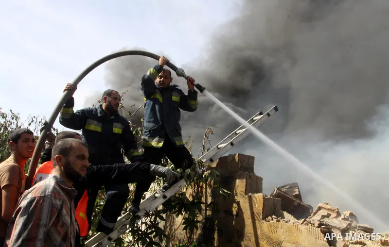 Firefighters try to extinguish a fire in a factory which according to Palestinians was hit by an Israeli air strike in Gaza November 16, 2012. Egyptian Prime Minister Hisham Kandil arrived in the Gaza Strip on Friday to...