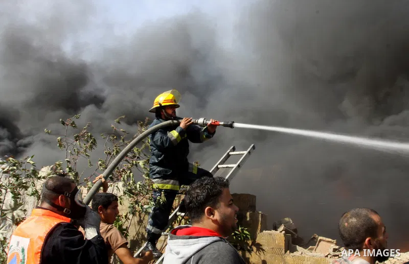 Firefighters try to extinguish a fire in a factory which according to Palestinians was hit by an Israeli air strike in Gaza November 16, 2012. Egyptian Prime Minister Hisham Kandil arrived in the Gaza Strip on Friday to...
