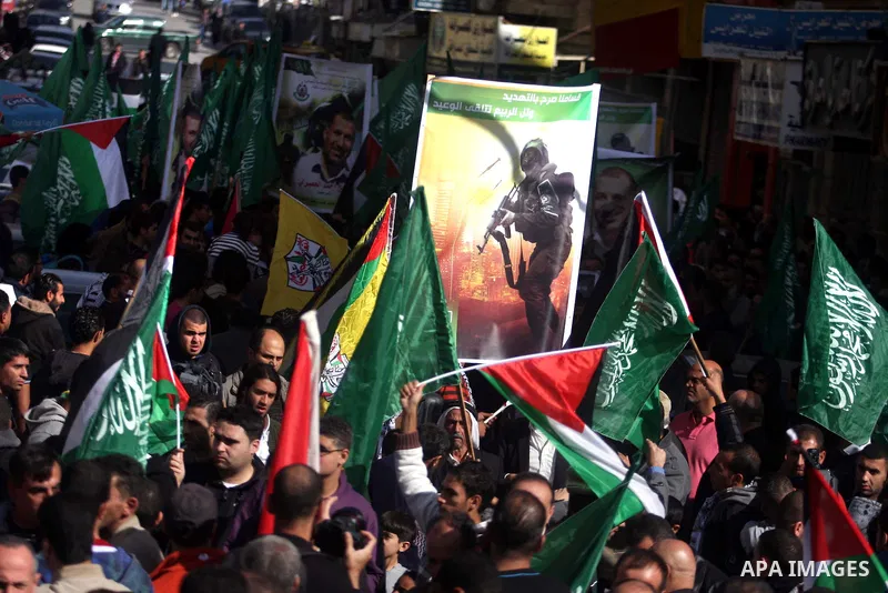 Palestinian Hamas supporters wave flags during a protest against Israel's operations in Gaza Strip, in the West Bank city of Ramallah 16 November 2012. Reports state that missiles continue to be fired on Israeli targets...