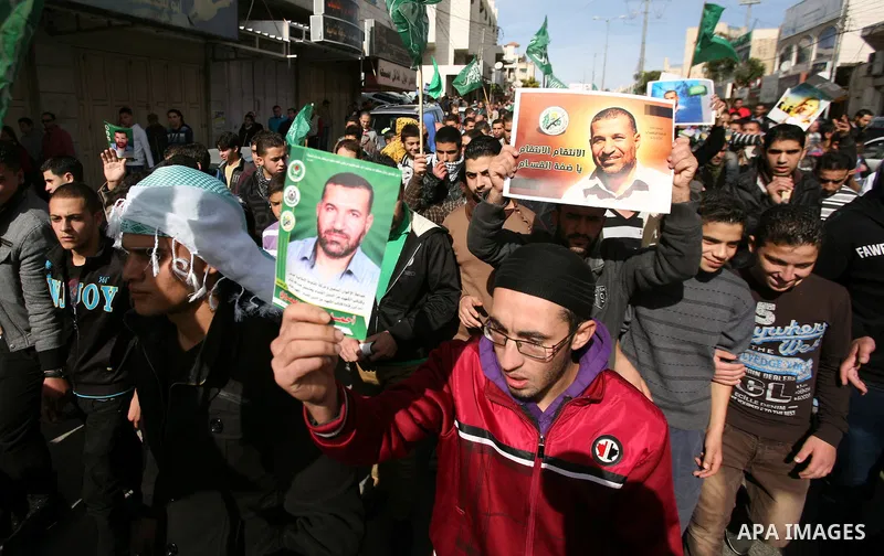 Palestinian Hamas supporters wave flags during a protest against Israel's operations in Gaza Strip, in the West Bank city of Hebron 16 November 2012. Reports state that missiles continue to be fired on Israeli targets by...