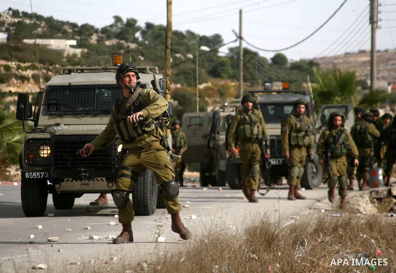 Israel soldiers fire tear gas at Palestinian demonstrators during clashes following a protest against Israel's operations in Gaza Strip in the village of Beit Ummar near the West Bank city of Hebron on November, 16, 2012...