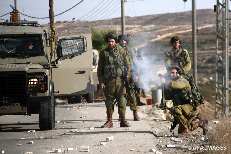 Israel soldiers fire tear gas at Palestinian demonstrators during clashes following a protest against Israel's operations in Gaza Strip in the village of Beit Ummar near the West Bank city of Hebron on November, 16, 2012...