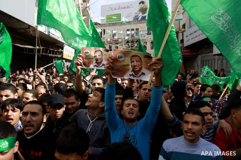 Palestinian Hamas supporters wave flags during a protest against Israel's operations in Gaza Strip, in the West Bank city of Nablus 16 November 2012. Reports state that missiles continue to be fired on Israeli targets by...