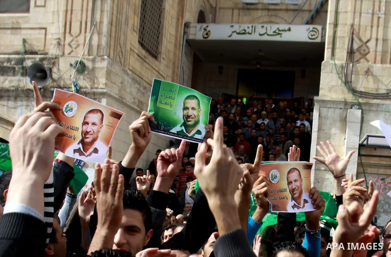 Palestinian Hamas supporters wave flags during a protest against Israel's operations in Gaza Strip, in the West Bank city of Nablus 16 November 2012. Reports state that missiles continue to be fired on Israeli targets by...