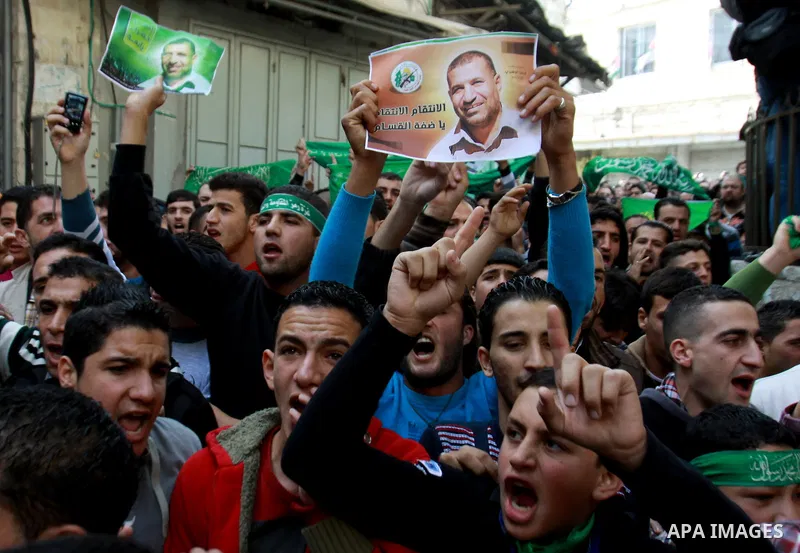 Palestinian Hamas supporters wave flags during a protest against Israel's operations in Gaza Strip, in the West Bank city of Nablus 16 November 2012. Reports state that missiles continue to be fired on Israeli targets by...