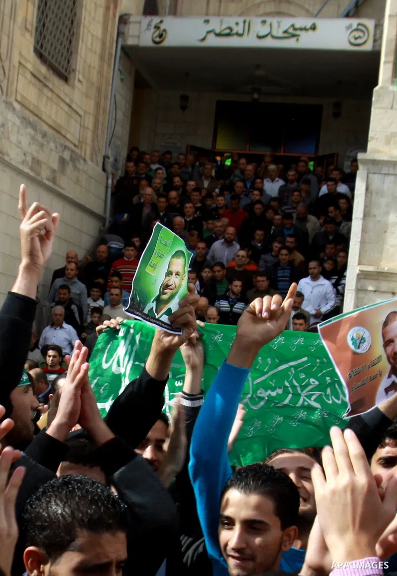 Palestinian Hamas supporters wave flags during a protest against Israel's operations in Gaza Strip, in the West Bank city of Nablus 16 November 2012. Reports state that missiles continue to be fired on Israeli targets by...