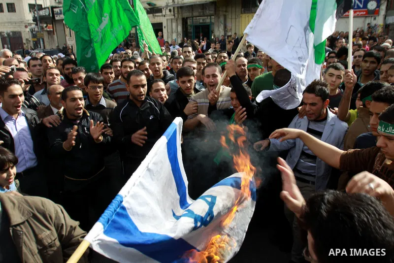 Palestinian Hamas supporters wave flags during a protest against Israel's operations in Gaza Strip, in the West Bank city of Nablus 16 November 2012. Reports state that missiles continue to be fired on Israeli targets by...