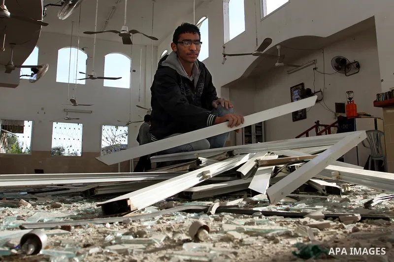 Palestinian youths inspect a destroyed mosque in Beit Hanun on the northern Gaza Strip following an Israeli air raid in Gaza City on November 16, 2012. Israel was condemned by much of the Arab world while securing Wester...