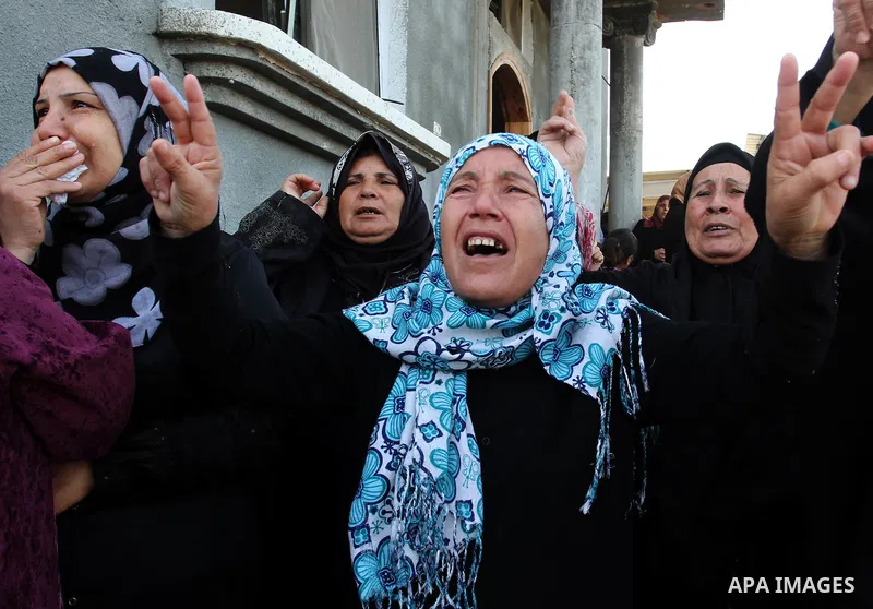 Palestinian women of Audi Naser 10 years, cries during his funeral after he was killed in an Israeli air strike, during his funeral in Beit Hanun, northern Gaza Strip on 16 November 2012. Missiles continue to be fired on...