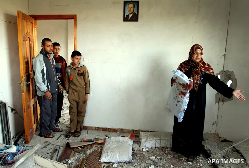 A Palestinian woman inspects the damage to her house after an Israeli airstrike in Beit Hanoun north Gaza Strip on 16 November 2012. Reports state that missiles continue to be fired on Israeli targets by Palestinian mili...