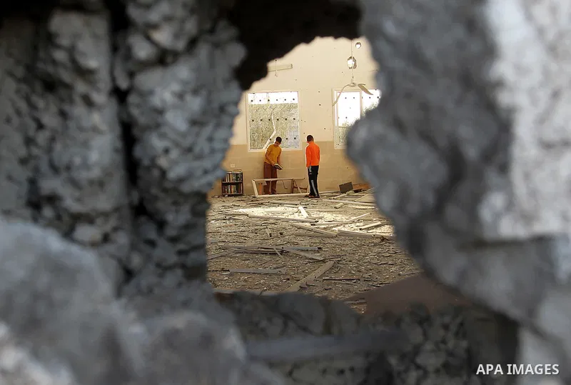 Palestinian youths inspect a destroyed house in Beit Hanun on the northern Gaza Strip following an Israeli air raid in Gaza City on November 16, 2012. Israel was condemned by much of the Arab world while securing Western...