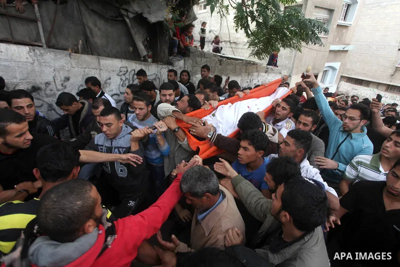 Palestinian mourners carry the bodies of Tahrer Salman and Mohammed Salman in Beit Lahia, north Gaza, Friday, Nov. 16, 2012. According to relatives, the two members of the Salman family were killed after an Israeli airst...