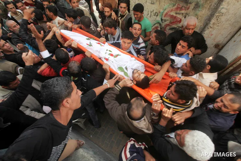Palestinian mourners carry the bodies of Tahrer Salman and Mohammed Salman in Beit Lahia, north Gaza, Friday, Nov. 16, 2012. According to relatives, the two members of the Salman family were killed after an Israeli airst...