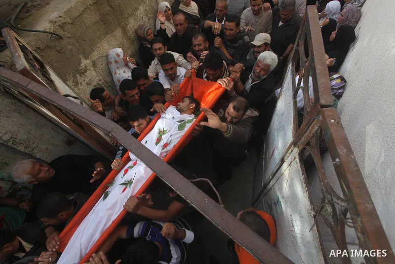 Palestinian mourners carry the bodies of Tahrer Salman and Mohammed Salman in Beit Lahia, north Gaza, Friday, Nov. 16, 2012. According to relatives, the two members of the Salman family were killed after an Israeli airst...