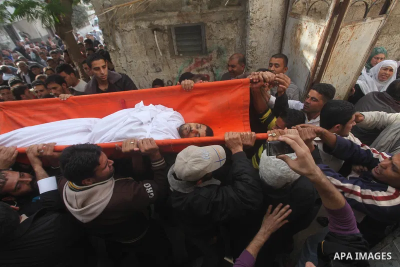 Palestinian mourners carry the bodies of Tahrer Salman and Mohammed Salman in Beit Lahia, north Gaza, Friday, Nov. 16, 2012. According to relatives, the two members of the Salman family were killed after an Israeli airst...