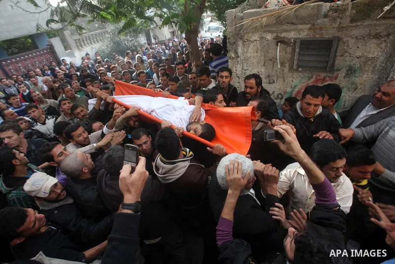 Palestinian mourners carry the bodies of Tahrer Salman and Mohammed Salman in Beit Lahia, north Gaza, Friday, Nov. 16, 2012. According to relatives, the two members of the Salman family were killed after an Israeli airst...