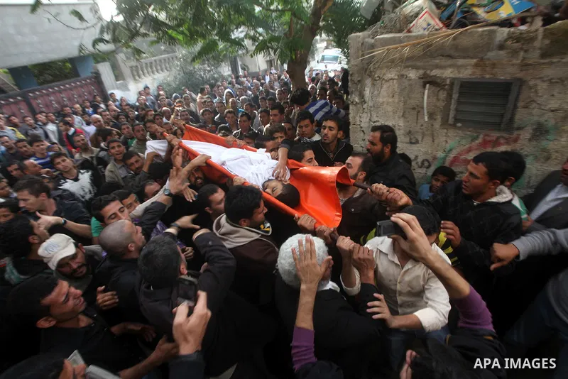 Palestinian mourners carry the bodies of Tahrer Salman and Mohammed Salman in Beit Lahia, north Gaza, Friday, Nov. 16, 2012. According to relatives, the two members of the Salman family were killed after an Israeli airst...