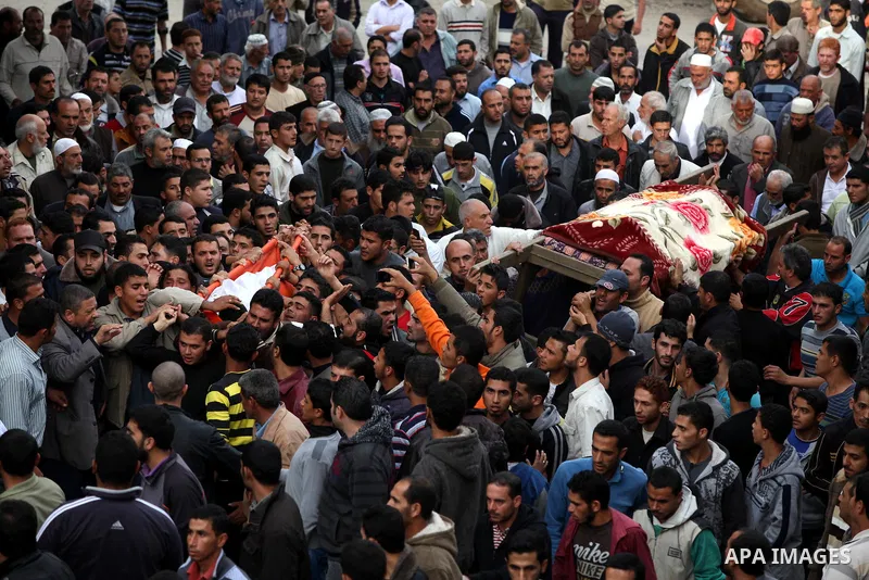 Palestinian mourners carry the bodies of Tahrer Salman and Mohammed Salman in Beit Lahia, north Gaza, Friday, Nov. 16, 2012. According to relatives, the two members of the Salman family were killed after an Israeli airst...