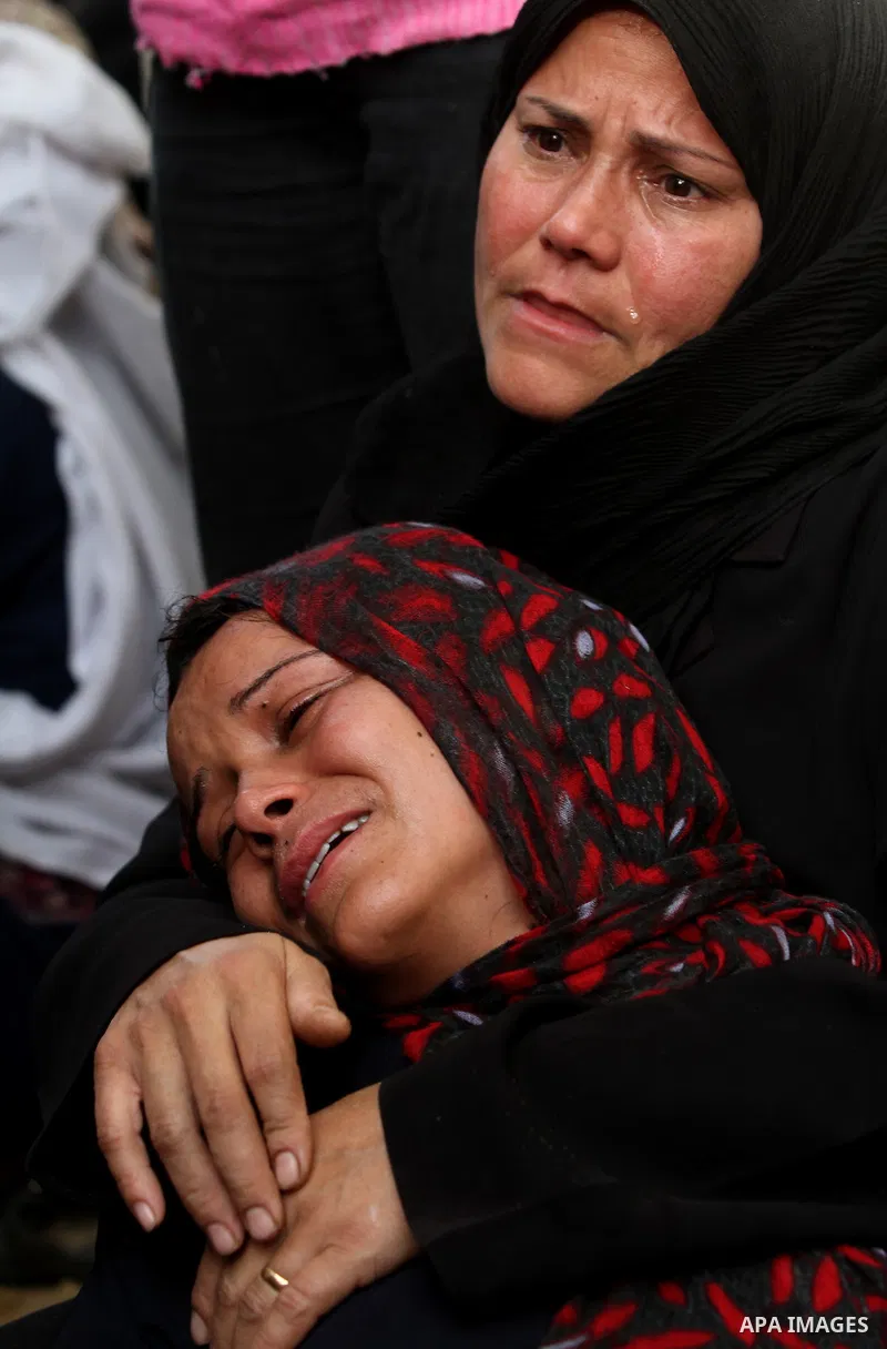 Palestinian women cry during the funeral of Tahrer Salman and Mohammed Salman in Beit Lahia, north Gaza, Friday, Nov. 16, 2012. According to relatives, the two members of the Salman family were killed after an Israeli ai...