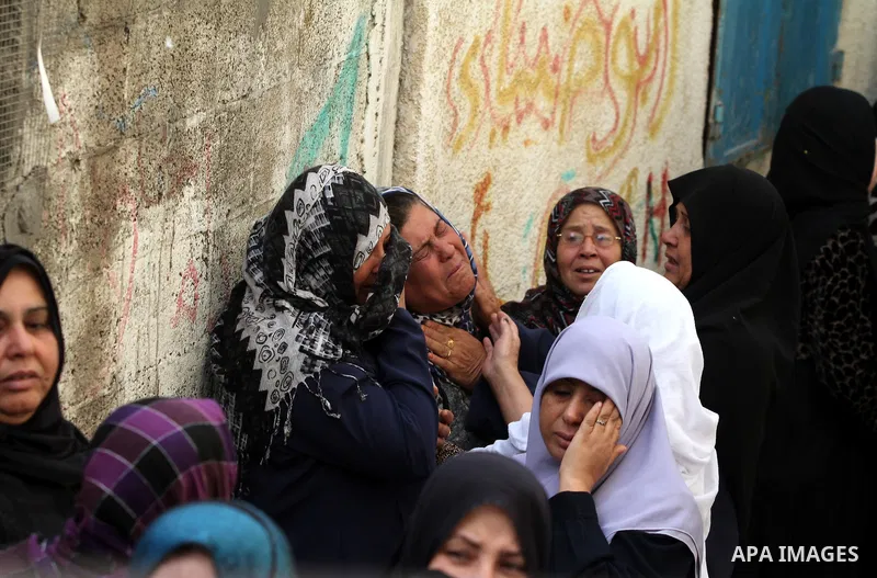 Palestinian women cry during the funeral of Tahrer Salman and Mohammed Salman in Beit Lahia, north Gaza, Friday, Nov. 16, 2012. According to relatives, the two members of the Salman family were killed after an Israeli ai...