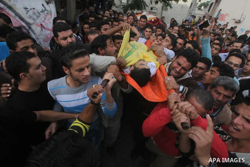 Palestinian mourners carry the bodies of Tahrer Salman and Mohammed Salman in Beit Lahia, north Gaza, Friday, Nov. 16, 2012. According to relatives, the two members of the Salman family were killed after an Israeli airst...