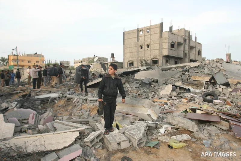 Palestinians inspect the rubble of the destroyed house of Hamas militant Mohammad Abu Shmala, following an Israeli air strike in Rafah, southern Gaza Strip, Friday, Nov. 16, 2012. Photo by Eyad Al Baba