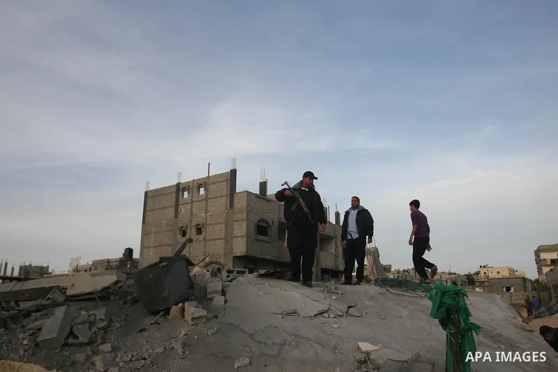 Palestinians inspect the rubble of the destroyed house of Hamas militant Mohammad Abu Shmala, following an Israeli air strike in Rafah, southern Gaza Strip, Friday, Nov. 16, 2012. Photo by Eyad Al Baba