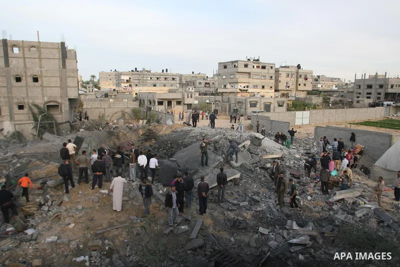 Palestinians inspect the rubble of the destroyed house of Hamas militant Mohammad Abu Shmala, following an Israeli air strike in Rafah, southern Gaza Strip, Friday, Nov. 16, 2012. Photo by Eyad Al Baba