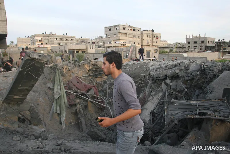 Palestinians inspect the rubble of the destroyed house of Hamas militant Mohammad Abu Shmala, following an Israeli air strike in Rafah, southern Gaza Strip, Friday, Nov. 16, 2012. Photo by Eyad Al Baba