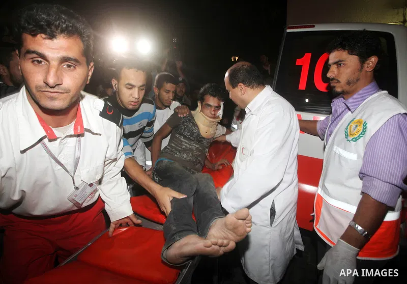 Palestinians carries an man into the treatment room of Shifa hospital following an Israeli airstrike, in Gaza City, Friday, Nov. 16, 2012. Fierce clashes between Israeli forces and Gaza militants are continuing for the t...