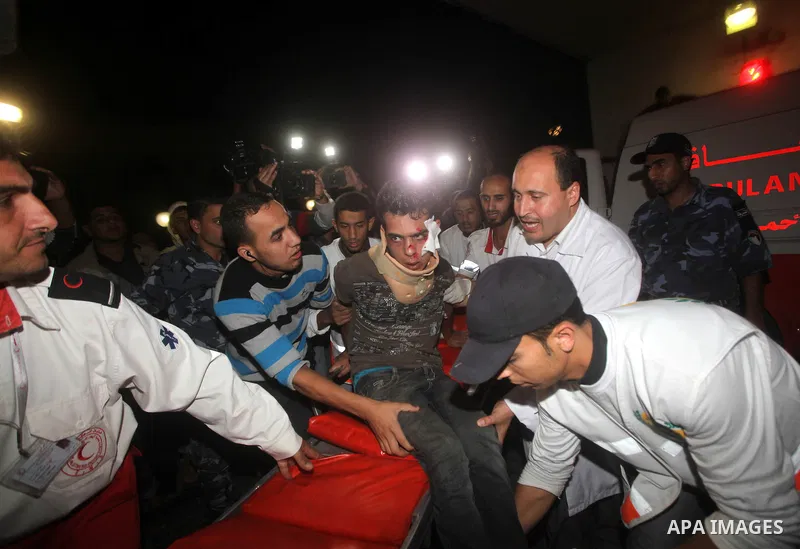Palestinians carries an man into the treatment room of Shifa hospital following an Israeli airstrike, in Gaza City, Friday, Nov. 16, 2012. Fierce clashes between Israeli forces and Gaza militants are continuing for the t...