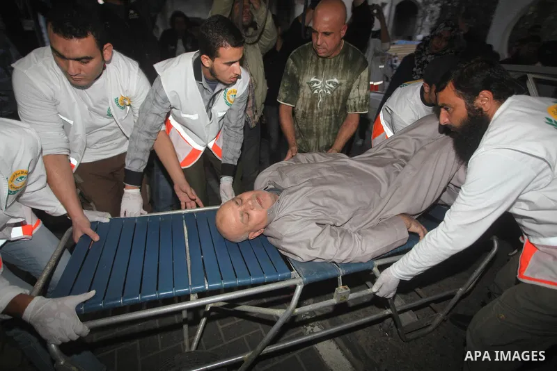 Palestinians carries an man into the treatment room of Shifa hospital following an Israeli airstrike, in Gaza City, Friday, Nov. 16, 2012. Fierce clashes between Israeli forces and Gaza militants are continuing for the t...