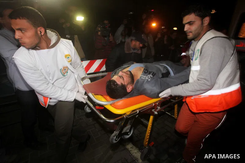 Palestinians carries an man into the treatment room of Shifa hospital following an Israeli airstrike, in Gaza City, Friday, Nov. 16, 2012. Fierce clashes between Israeli forces and Gaza militants are continuing for the t...