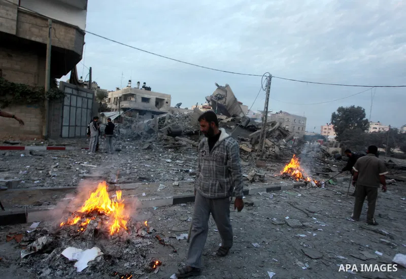 Palestinians inspect the destroyed office building of Hamas Prime Minister Ismail Haniyeh in Gaza City November 17, 2012. Israeli aircraft pounded Hamas government buildings in Gaza on Saturday, including the building ho...